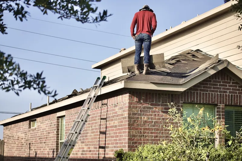 Professional roofer working on a residential roof in Country Life Homes